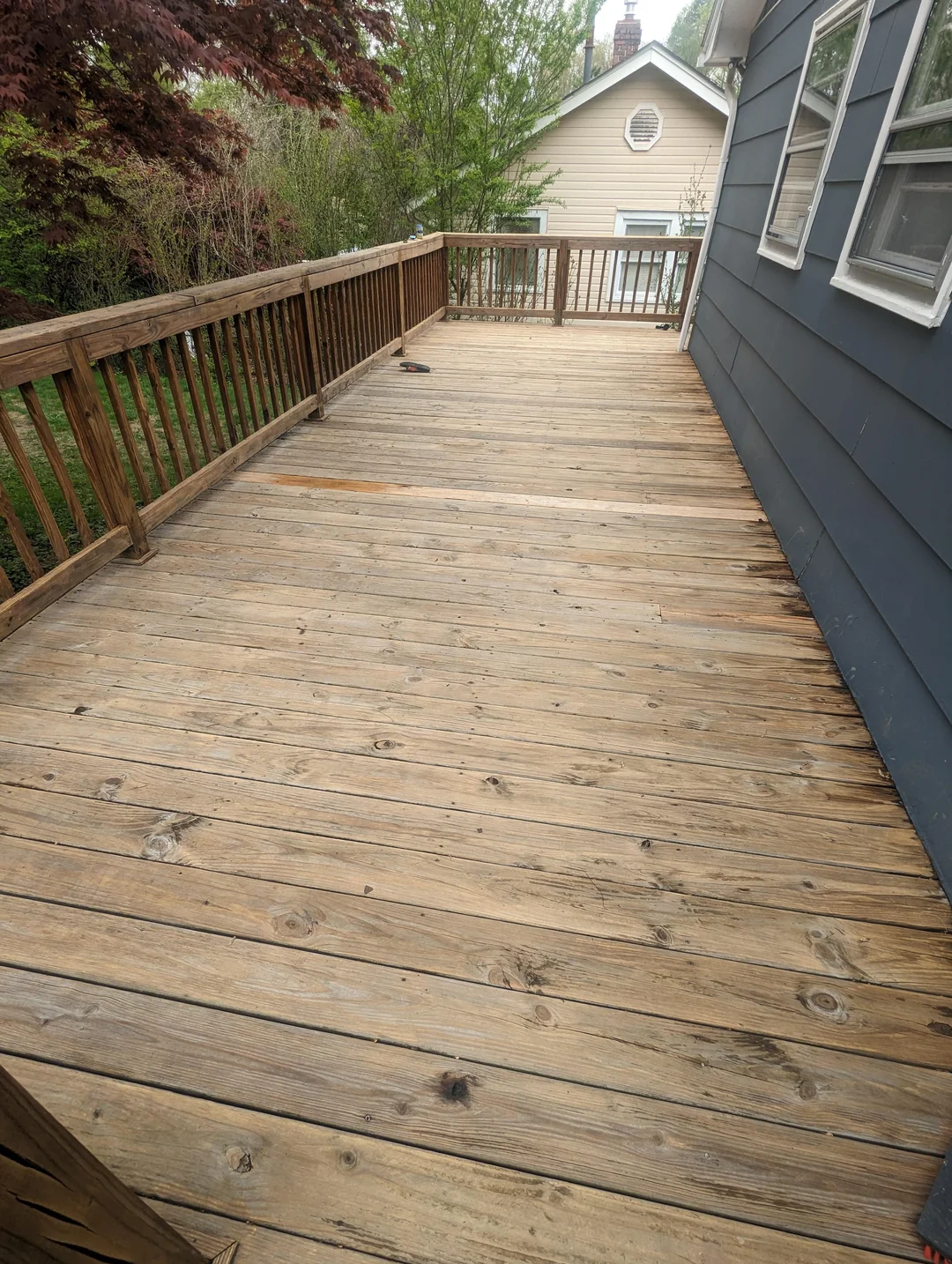 Weathered grey wood fence before staining