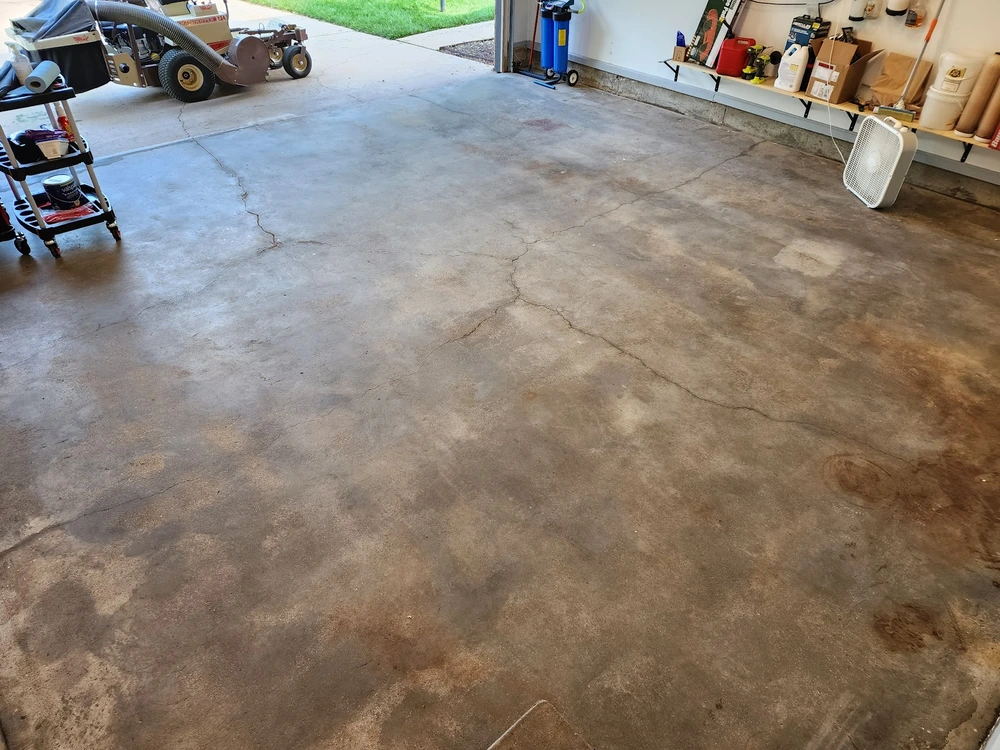 Cracked and stained concrete garage floor in Omaha